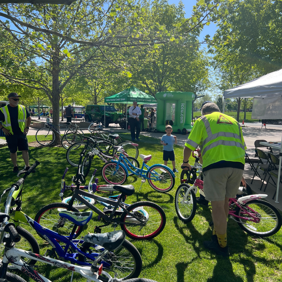 Refurbished bikes being lines up on the grass at a Meridian park for Recycle a Bicycle